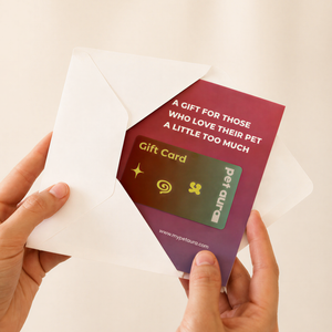 A person holds an open white envelope revealing a pet-themed gift card. The card has a maroon-to-purple gradient background with white text reading 'A GIFT FOR THOSE WHO LOVE THEIR PET A LITTLE TOO MUCH' and a sample gift card design layered inside.