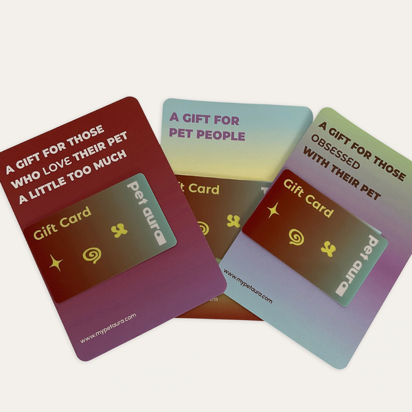 Three pet-themed gift cards with gradient backgrounds and humorous pet-related quotes, arranged on a light beige background. The cards feature pet auras and paw print graphics