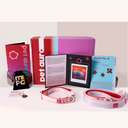 A pet collection displayed on a white background, including a red and purple Pet Aura box, a pink and purple, a black drawstring pouch, a small charm, a booklet, and a pink-and-white dog collars and lead.