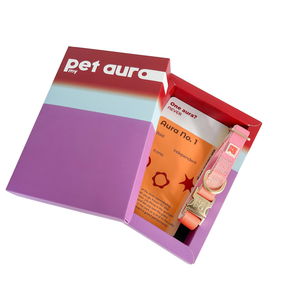 A gift set in a purple and red box labeled 'my pet aura' containing a pink pet collar and an orange card labeled 'Aura no. 1'.