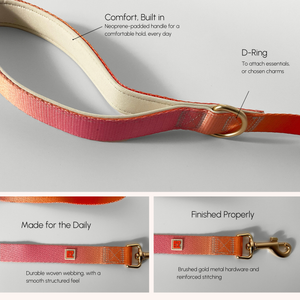 A pink and orange woven leather strap with a cream padded handle, shown with callout labels pointing to the D-Ring and comfort features, plus two smaller inset close-ups of hardware and webbing details.